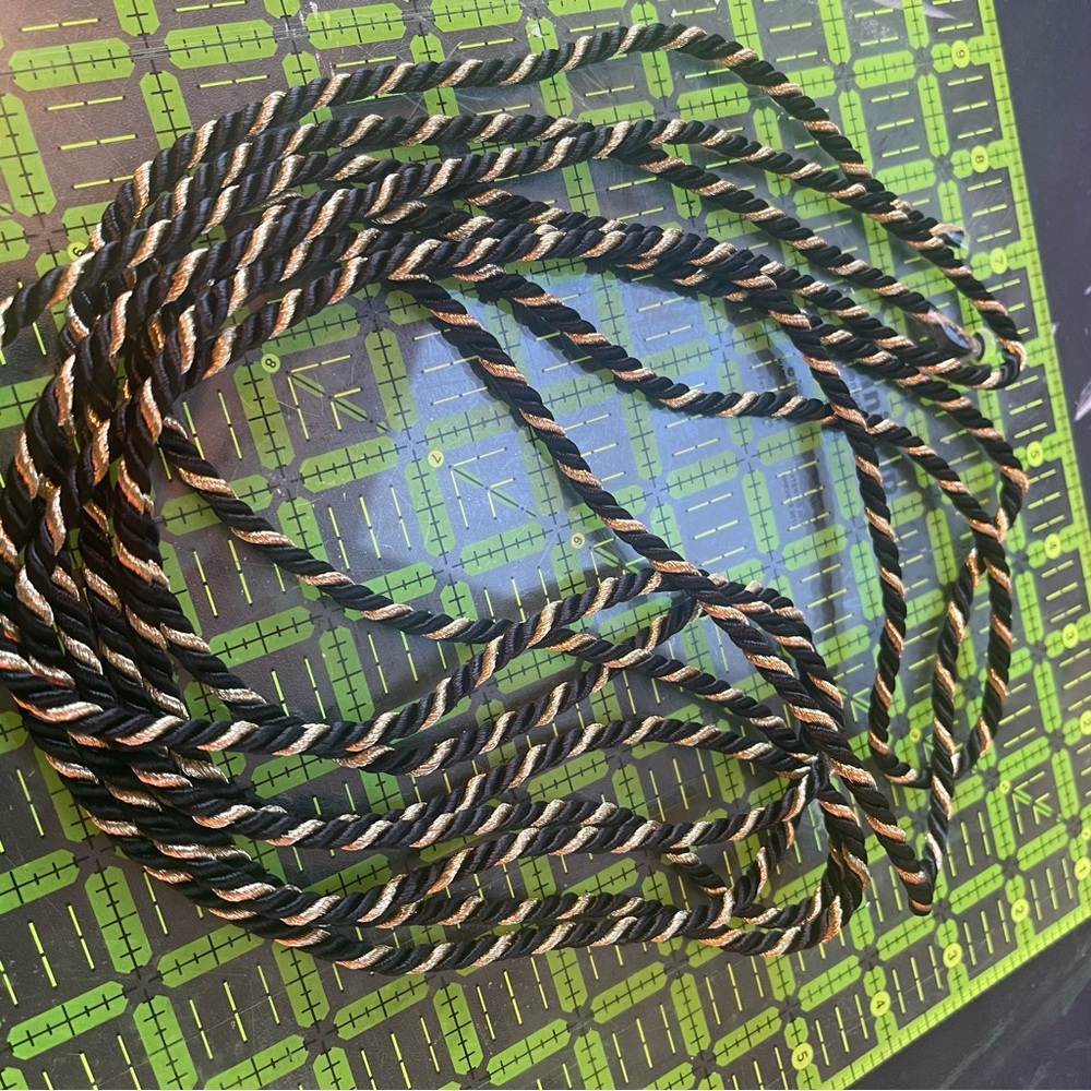 Black and gold drapery cord